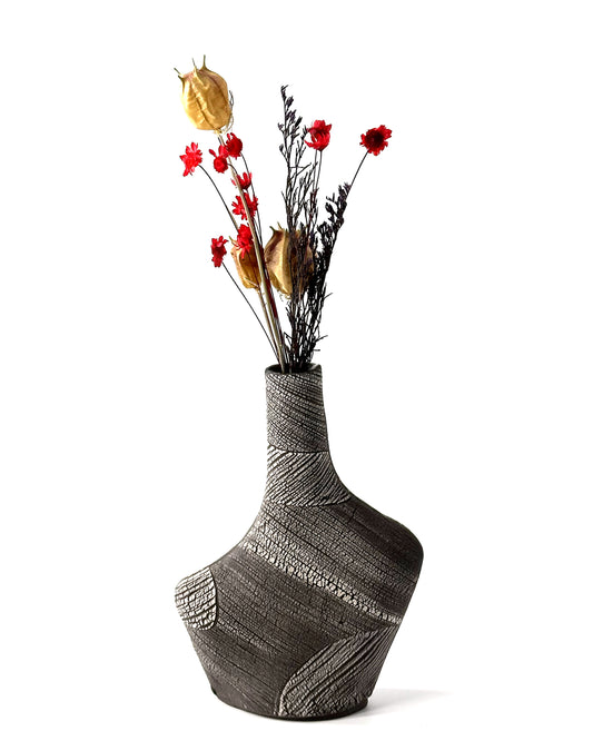 Textured vase with flowers on a white background